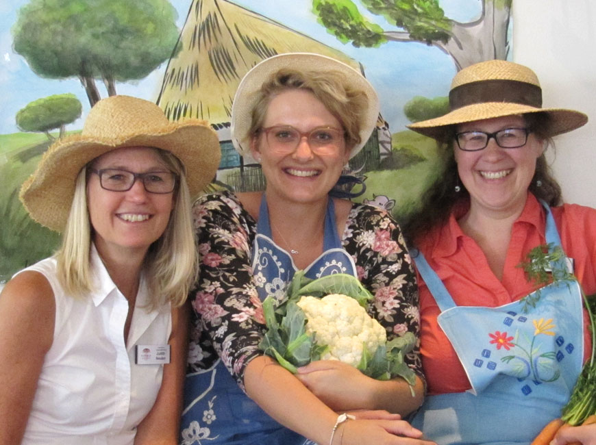 Drei Mitarbeiterinnen vom Kurhaus Hennef bei der Aktion "Urlaub ohne Koffer". Alle drei tragen Strohhüte in Anlehnung an das Thema.